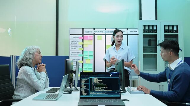 A diverse team of software developers collaborates on agile project management, brainstorming strategies at a kanban board in a modern tech office.