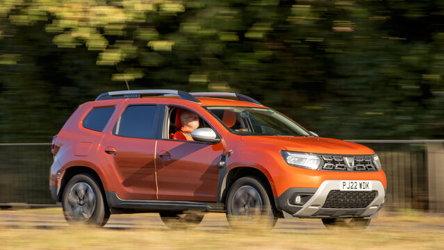 Milton Keynes; UK - Sept. 5th 2026: 2022 orange Dacia Duster SUV car driving on a British road