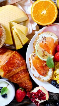 Gourmet brunch table layout with croissant salmon toast cheese and fresh fruit