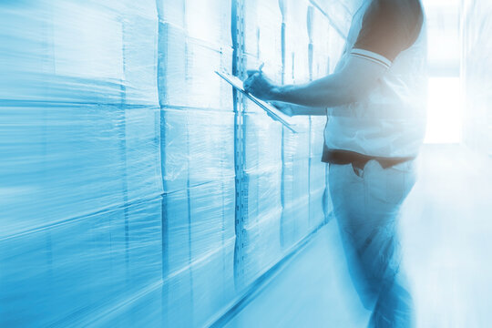 Workers Checking a Package Boxes in Warehouse. Cardboard Boxes, Package. Business e- commerce. Storage Warehouse. Delivering Supply Chain, Supplies Shipment. Warehouse Shipping Logistics.	
