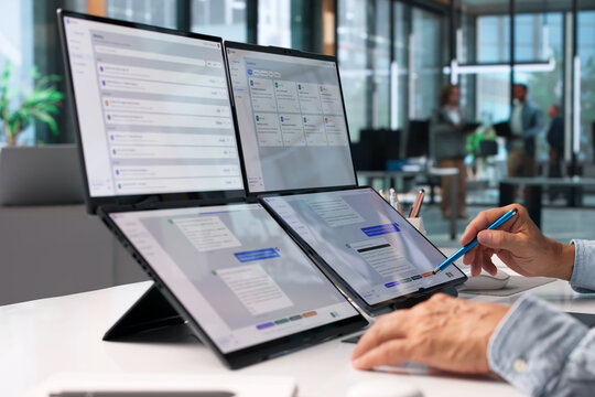 Customer Support Specialist Multitasks On Foldable Laptop
