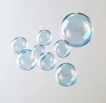 Group of clear glass spheres floating against white