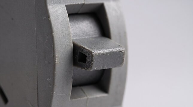 Macro view of a gray electrical circuit breaker switch handle closeup