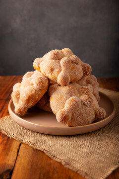Pan de Muerto. Traditional Mexican sweet bread coated with sugar on a plate, perfect for Day of the Dead.
