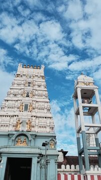 White ornamental Hindu temple gopuram against a blue sky at historic Munneswaram Temple in Sri Lanka.