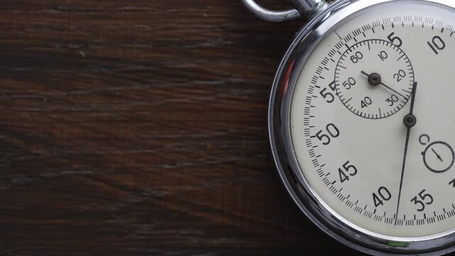 Detail of antique mechanical pocket stopwatch in a metal chrome-plated case, close up