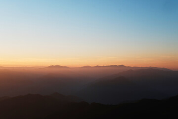 Fototapeta premium Beautiful landscape of golden sunset on valley mountain peak in Thailand