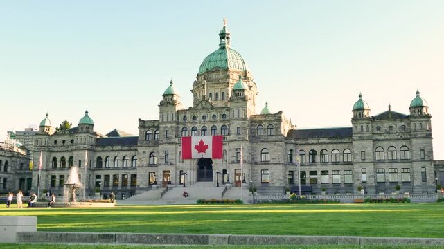 Victoria, British Columbia, Canada - September 18, 2026: British Columbia Parliament Buildings with giant Canadian flag
