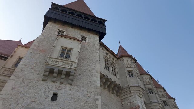 Low angle view of Gothic towers and ornate facade at Corvin Castle in Hunedoara Romania