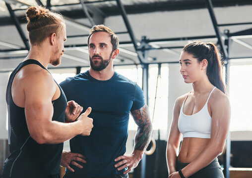 Conversation, group and people in gym for fitness, workout and advice for wellness and chat. Bodybuilder club, men and woman in health center for support with exercise, tips and personal trainer