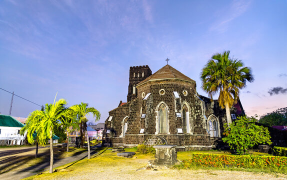 The historic St George's Anglican Church made of volcanic stone under a blue sunset sky in Basseterre, Saint Kitts and Nevis