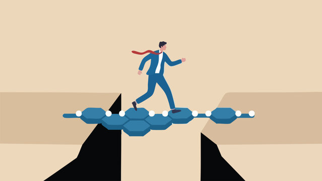 Businessman running across a bridge made of blue hexagonal tiles over a deep chasm
