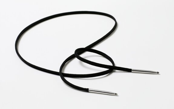 Black braided shoelaces with metal aglets on white