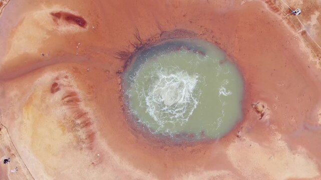 aerial close up turquoise devils eye bubbling mineral spring desert qinghai china