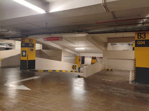 Empty Underground Parking Garage Interior with Ramp and Concrete Structure
