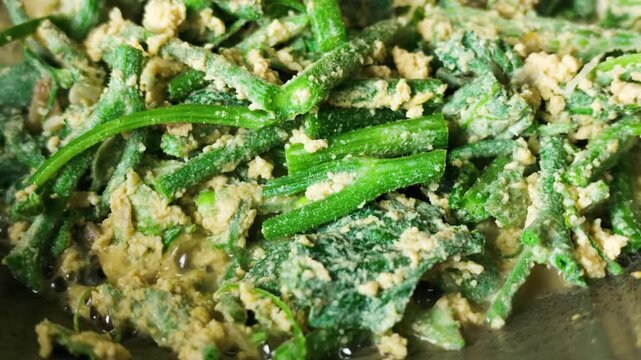 Slow Motion of Stir-Frying Chayote Shoots with Egg in Wok
