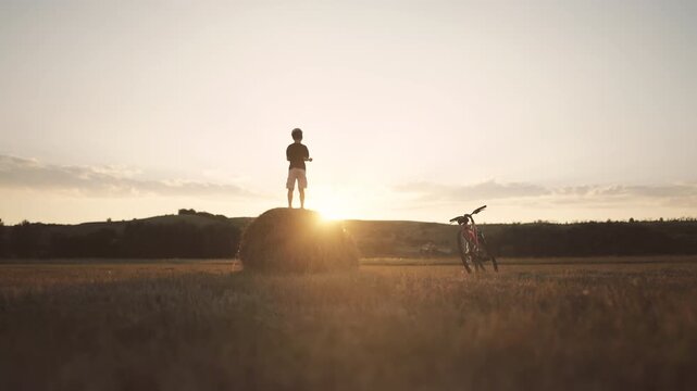 Happy childhood moments, little boy jumping on haystack in country, enjoy summer . Merry summer vacation in countryside, preteen boy feeling happiness and joy, positive emotions and active lifestyle