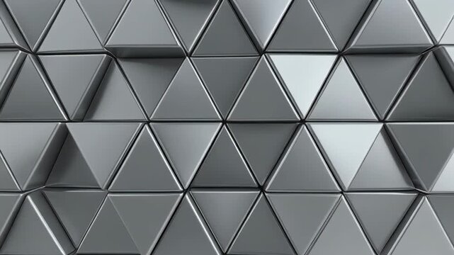 Abstract metallic triangles moving in seamless cinematic motion with subtle light shifts