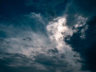 Fototapeta premium Dramatic Cumulus Clouds with Sunlight Breaking Through Blue Sky