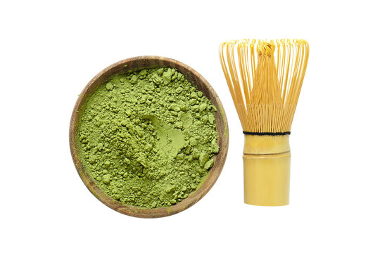 Matcha. Bowl filled with vibrant matcha powder beside bamboo whisk. PNG