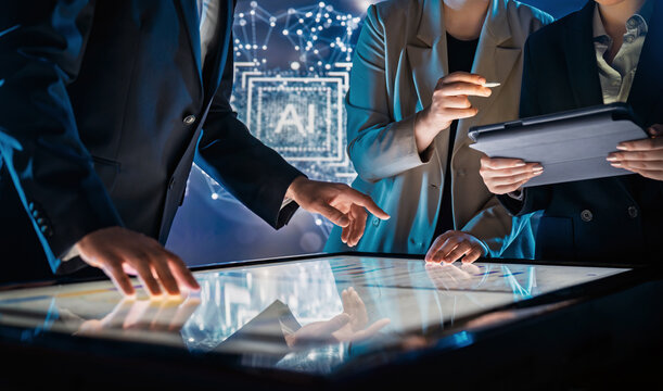 Business Team Collaborating on Interactive Touchscreen Table in Futuristic Office