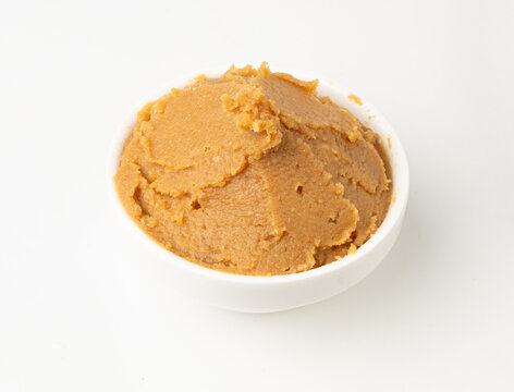 Miso paste isolated. Japanese shiro miso seasoning sauce, fermented soybean spread, brown soy cream