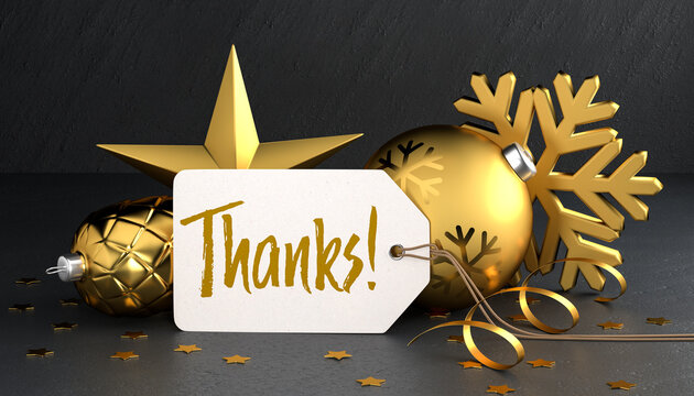 Christmas - Gift Tag with the message "Thanks!" on a black stone background leaning against gold colored christmas ornaments around.