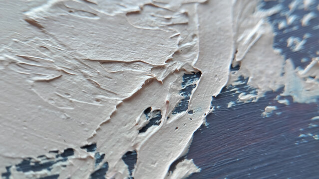 Close up view of thick white and light blue oil paint stroke texture on a canvas background. abstract art texture, creative hobby background, impasto painting technique.