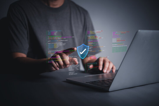 Cybersecurity code protection on laptop with shield verification icon for secure