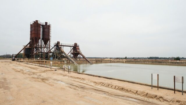 Sand and gravel wash plant standing beside pale silt settling ponds