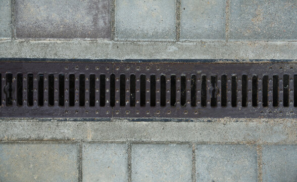 Drainage grate storm drain line on paving slabs top view
