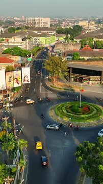 Busy UGM roundabout surrounded by Yogyakarta urban traffic