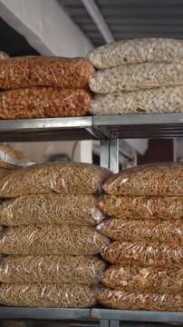 Assorted packaged namkeen and sev snacks stacked on metal shelves in an Indian shop