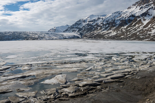 Broken chunks of dirty ice on a lake in Recherchefjorden, Svalbard, Norway