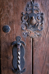 Wooden door with wrought iron details of The Sanctuary of The Vera Cruz in Caravaca de la Cruz town © SoniaBonet