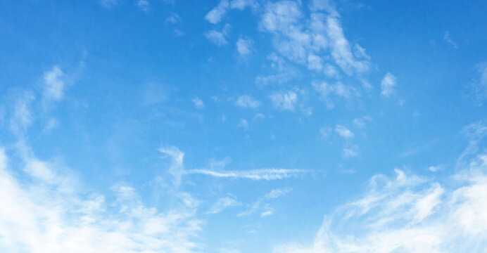 Clear blue sky with wispy white clouds