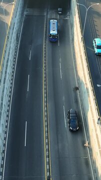 Top down aerial view of truck traveling across urban overpass