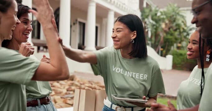Happy, volunteer and winning with high five for charity success or community mission together. Excited, people or NGO group with smile, fist pump or celebration for team donation or welfare outreach
