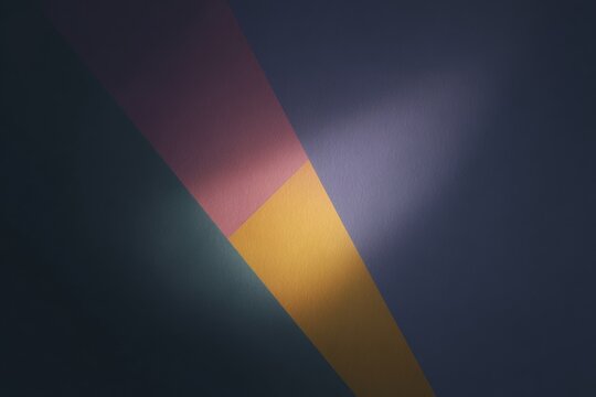 A dark blue background with a gradient of colors including yellow pink and purple. the colors blend together to create a and eyecatching wallpaper.