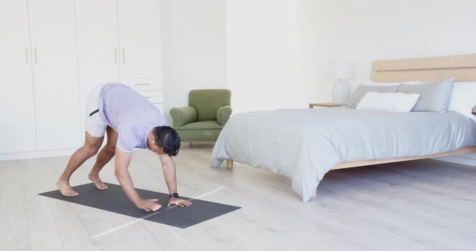 Lifestyle videos indoor of people doing activities at home, practicing yoga, man doing upward dog po