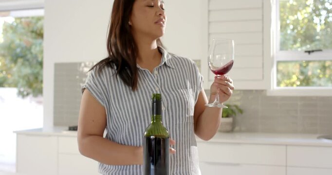 Lifestyle videos indoor of people doing activities at home, enjoying glass of red wine, woman drinki