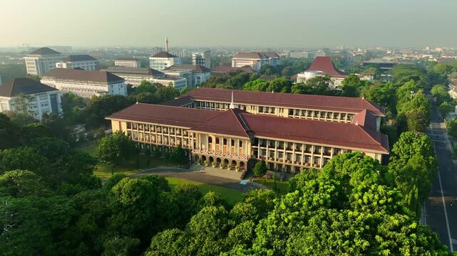 Aerial view of iconic UGM campus building surrounded by greenery
