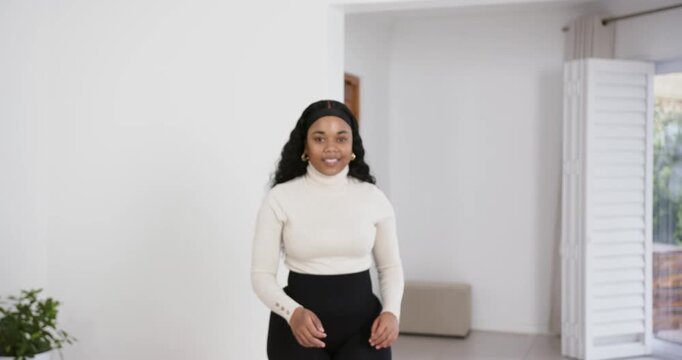 High speed photography for dynamic scenes, woman in turtleneck looking away, walking indoors with th