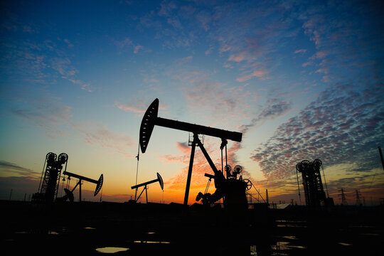 The oil pump, industrial equipment. Oil field site, oil pumps are running.