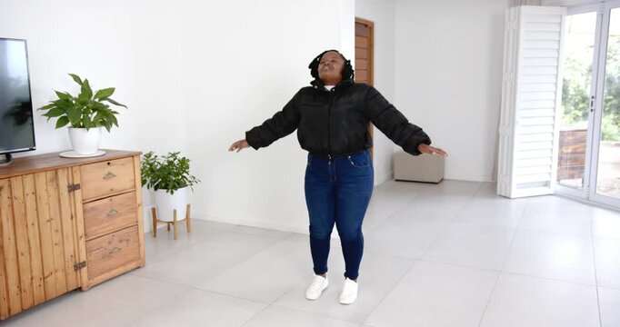 High speed photography for dynamic scenes, standing in living room, woman wearing black jacket and j