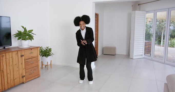High speed photography for dynamic scenes, dancing joyfully, woman in black coat enjoying music in l