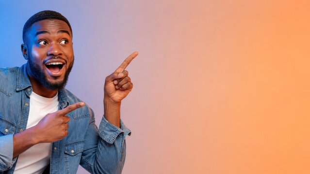 Excited african american man pointing fingers at copy space, looking at amazing offer or big sale on orange background