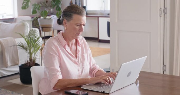 Lifestyle videos indoor of people doing activities at home, Typing on laptop, senior woman working f
