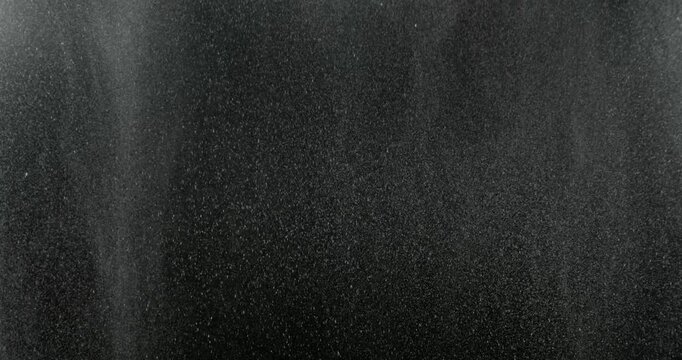 Realistic rain drops falling on a black background creating a natural weather VFX overlay ideal for compositing visual effects digital artwork atmospheric scenes and graphic design