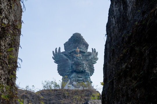 BALI, INDONESIA &ndash; OCTOBER 19, 2024: Gigantic GWK statue framed between steep limestone canyon walls at GWK Park in Bali.